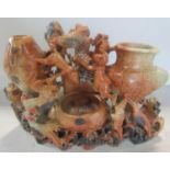 A Chinese carved soapstone triple vase inkwell decorated with monkeys, cockerels, birds and a bat,
