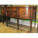 A Regency mahogany D end sideboard enclosed by an arrangement of drawers and cupboards, raised on