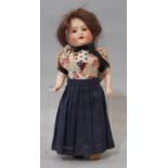 Small early 20th century bisque head doll by Armand Marseille, height 22cm, with closing blue