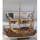 A wooden model sailing ship HMS Gloucester 9as found) on a stand and partially made model kit of the
