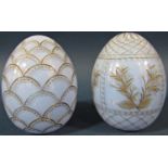 A pale blue cut glass and gilded Faberge style Easter egg with fish scale design and another pale
