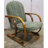 An Art Deco open armchair with upholstered seat and arched back raised on cantilever supports