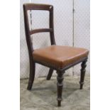 A set of four Victorian walnut dining chairs with moulded frames, upholstered seats raised on turned