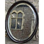 An Edwardian wall mirror of oval form with bevelled edge plate and beaded slip within a moulded