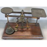 A set of 19th century postal scales with an incomplete and odd set of weights.