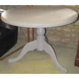 A solid pine breakfast table with painted finish, the circular top with moulded outline raised on