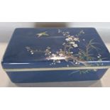 A Japanese blue cloisonné box with cherry blossom and a single green bird to the lid. 16.5cm wide.