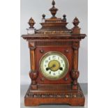 A late 19th century bracket clock in a walnut case with eight day striking movement, together with a