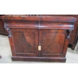 A Victorian mahogany chiffonier enclosed by a pair of arched panelled doors beneath two frieze