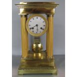 A Regency period portico clock in gilded brass with eight day striking movement