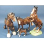 A collection of Beswick horses comprising rearing example, mare and foal and a shire horse example