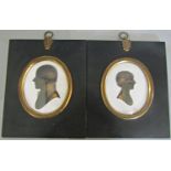 Pair of silhouette couple portraits of Major and Mrs. Greene of Calcutta on plaster wit gilt