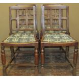 A set of four arts and crafts style oak low back dining chairs with chamfered splats over drop