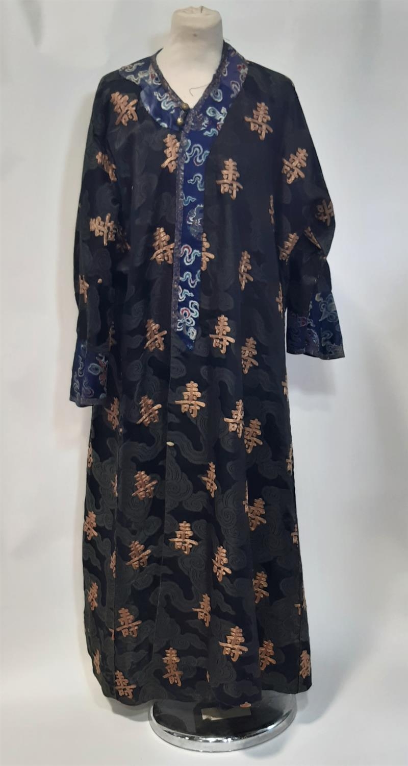 Oriental vintage kimono gown made of patterned black silk embroidered with goldwork characters and