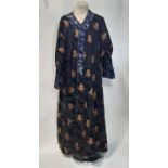 Oriental vintage kimono gown made of patterned black silk embroidered with goldwork characters and