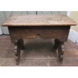 An Old English oak stool with plank top, raised on shaped and carved splay supports, 52cm wide