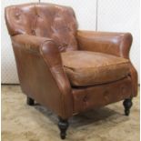 A Victorian style tan leather upholstered drawing room chair with swept arms, button back and