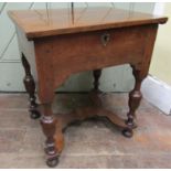 A small antique side table with rising lid in mixed woods including walnut and mahogany, raised on