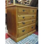 A younger stripped pine bedroom chest in the Georgian style of two short over three long graduated