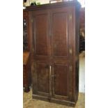 A 19th century oak side cupboard, freestanding and enclosed by a pair of rectangular fielded