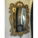 A wall mirror with rococo style C scroll and acanthus frame with gilt finish, 54cm wide x 92cm high