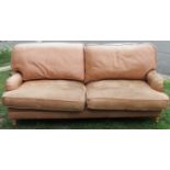 A Sofa Workshop contemporary low deep seated light brown leather upholstered sofa, loosely in the