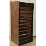An early 20th century walnut floorstanding pedestal filing cabinet enclosed by a rise and fall