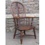 A Georgian hoop back elbow chair in elm and ash wood with crinoline stretcher