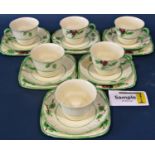 A Crown Devon tea service for six with hand painted floral detail within green banded borders,
