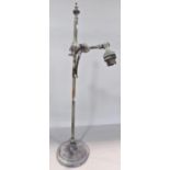An early 20th century bronze desk lamp with an adjustable arm, on a weighted circular base, 50cm
