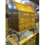 An Edwardian walnut and figured walnut veneered bureau, the fall flap enclosing a simply fitted