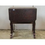 A late Victorian/Edwardian walnut drop leaf occasional table with decorative carved foliate detail