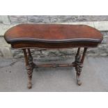 A Victorian walnut and figured walnut veneered fold over top card table with serpentine moulded