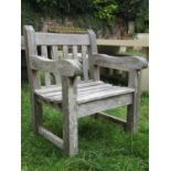 A weathered heavy gauge teak garden open armchair with slatted seat and back, 70 cm wide