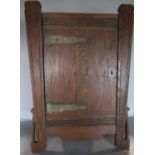 A small Arts & Crafts oak hanging wall cabinet 50cm x 34.5cm.