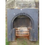 A reclaimed cast iron fire insert with decorative floral relief detail, 91cm wide x 97cm high