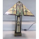 An Art Deco “Tiffany” style table lamp with a square floral ”lead” panelled shade set on a