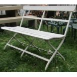 A cream painted folding square tubular steel framed two seat garden bench with wooden slatted seat