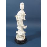 A Blanc De Chine figure of a Buddhistic type character set upon a lotus flower base with wooden