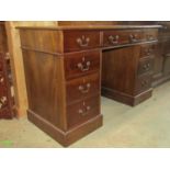 A reproduction Georgian style mahogany kneehole twin pedestal desk with inset leather writing