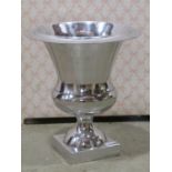 Four contemporary cast alloy urn shaped table vases with flared rims and square bases, 26 cm
