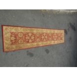 A Wilton type runner with a Middle Eastern pattern, 275cm x 64cm approx.