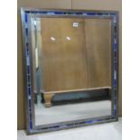 A heavy steel framed mirror, rectangular form, the framework enclosing repeating leaded light