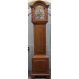 An early 19th century oak longcase clock, the hood with arched outline enclosing a broken arched
