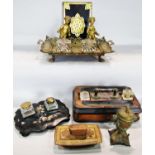 A bronze ink stand with two cherubs, a papier-mâché ink stand, a simple wooden ink stand, a blotter,