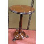 A 19th century mahogany occasional table set on a circular moulded base with lions paw feet, on a
