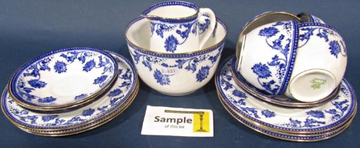 An Aynsley tea service for twelve with blue and white floral detail, set within gilded borders