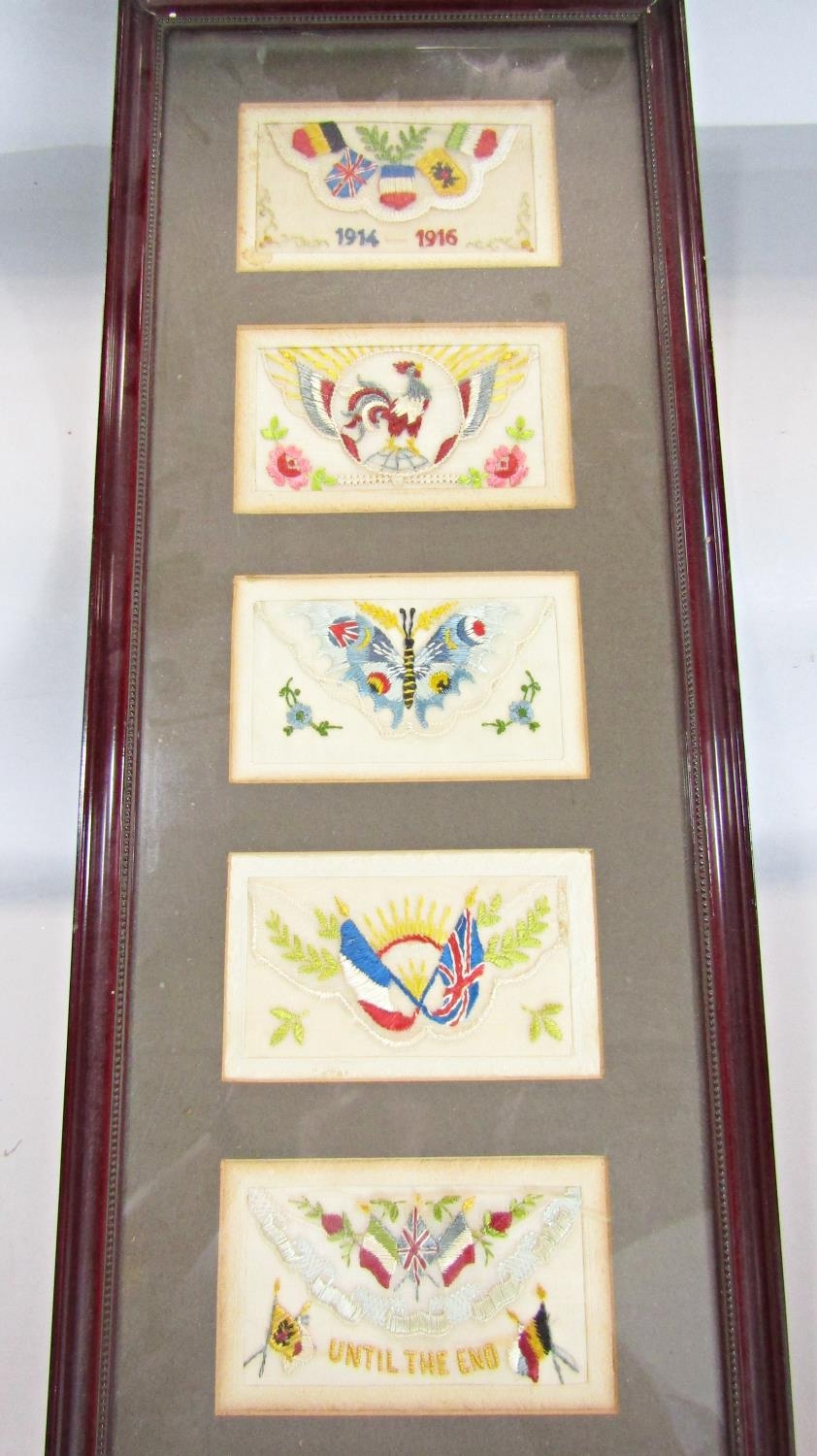 Ten WWI embroidered silk post cards displayed in two glazed frames.