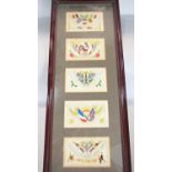 Ten WWI embroidered silk post cards displayed in two glazed frames.