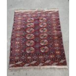 A Turkoman rug with two rows of elephant foot gul on purple ground, 110cm x90cm